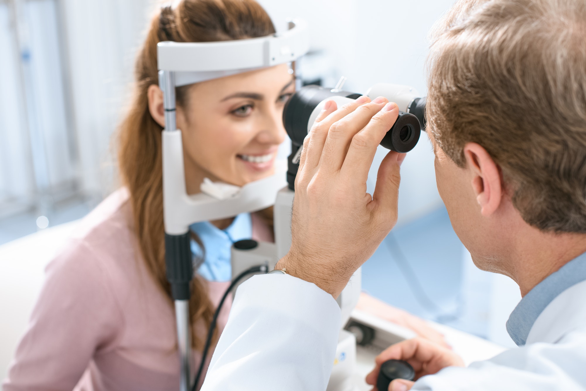 oculist-examining-patient-vision-with-slit-lamp-in-clinic.jpg